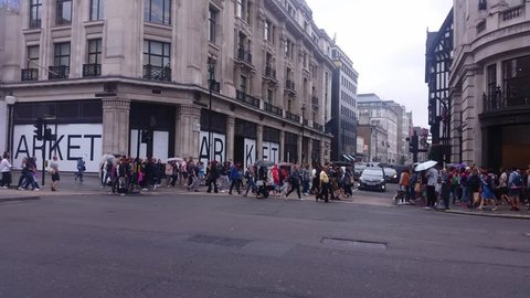 London, United Kingdom (UK) - 07 14 2017: Many people shopping in Oxford Street in London showing the street and the traffic.