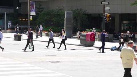 Toronto, Canada - 06 10 2018: Pedestrians crossing the road at a busy intersection