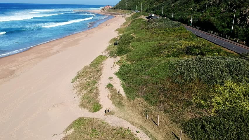 Aerial view of the beach bluff Durban, South Africa. Forward flight along the coast road following the beach.