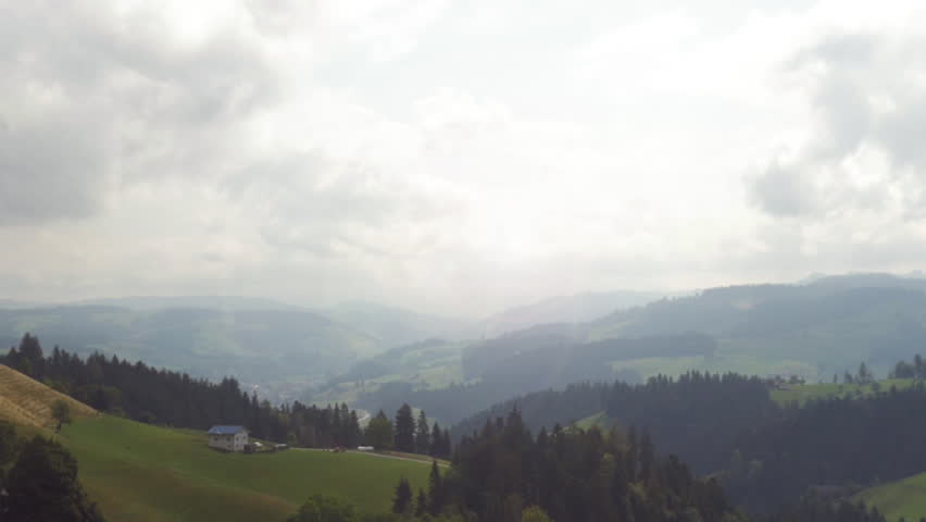 Emmental valley landscape panorama of green rolling hills and clouds in central Switzerland.