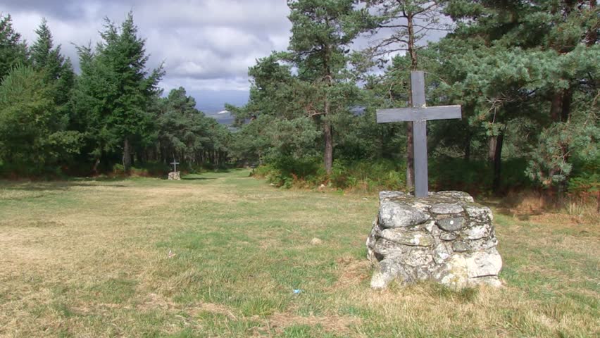 PATH WITH CROSSES WITH THE MOVING LIGHT OF THE SUN