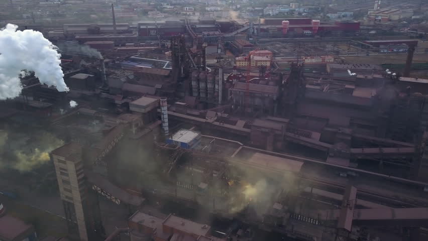 Panoramic view of heavy industry with detrimental impact on nature; CO2 emissions, toxic poisonous gases from chimneys; rusty dirty pipelines and clouds of smoke;  Royalty-Free Stock Footage #1017723421