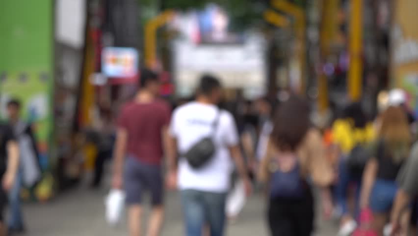 Blurred Locals and tourists walking at the Ximending street market in Taipei, Taiwan, This street is the gathering place for youngster in Taipei. Royalty-Free Stock Footage #1017728737