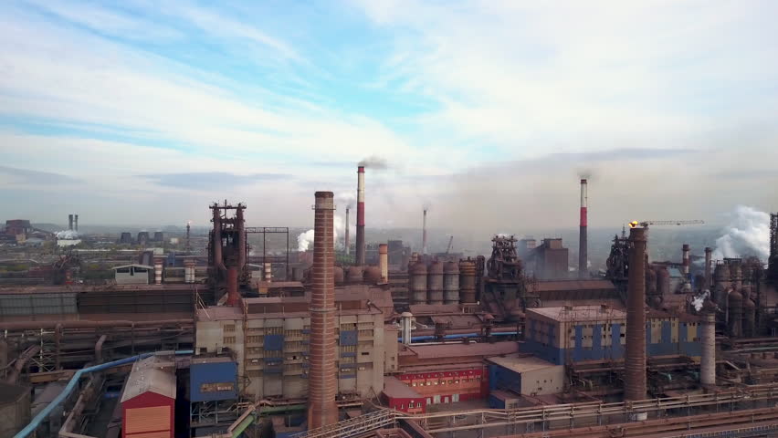 Drone footage close to steel works and blast furnaces, smoke tubes and chimneys, pipelines; elements of production exuding toxic fumes; limited natural resources; one of the world largest steel plant Royalty-Free Stock Footage #1017728773