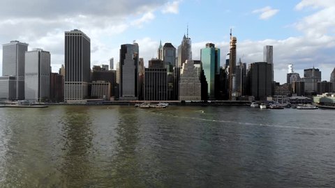 Stunning aerial view of Manhattan Skyline, New York, USA. Panoramic Skyline with skyscrapers and financial district and Hudson river from Brooklyn pier