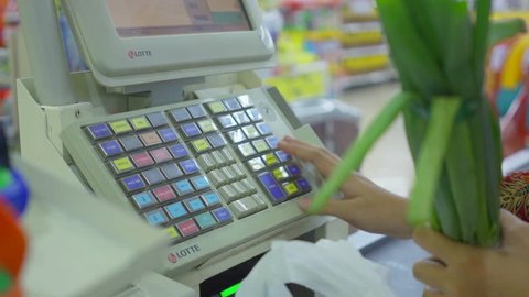 JAKARTA, Indonesia - October 10, 2018: hand registering orders on the cash register machine in the supermarket shop. Shot in 4k resolution