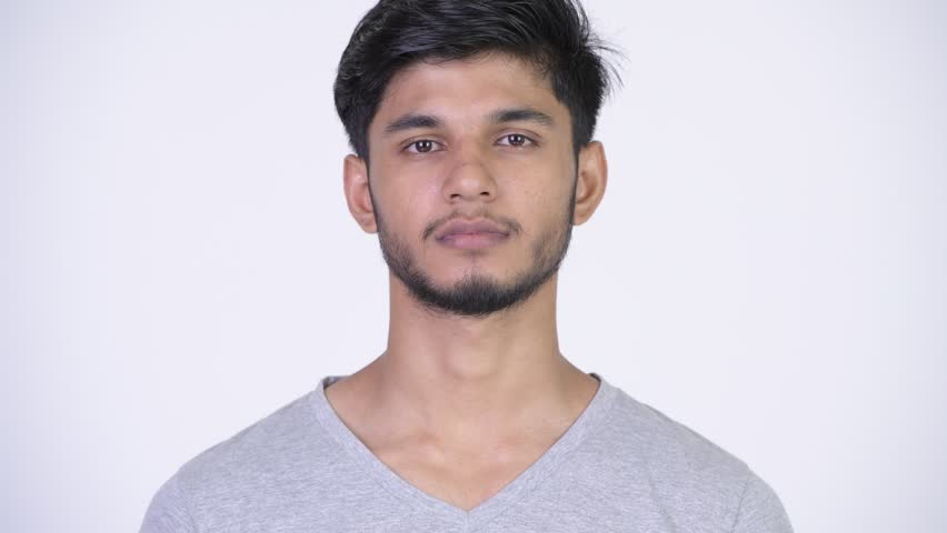 Young happy bearded Indian man smiling