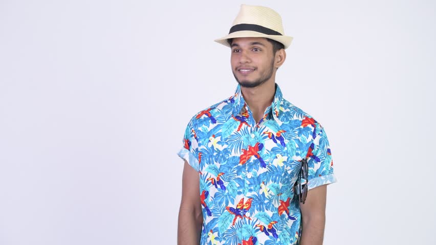 Young happy bearded Indian tourist man pointing finger