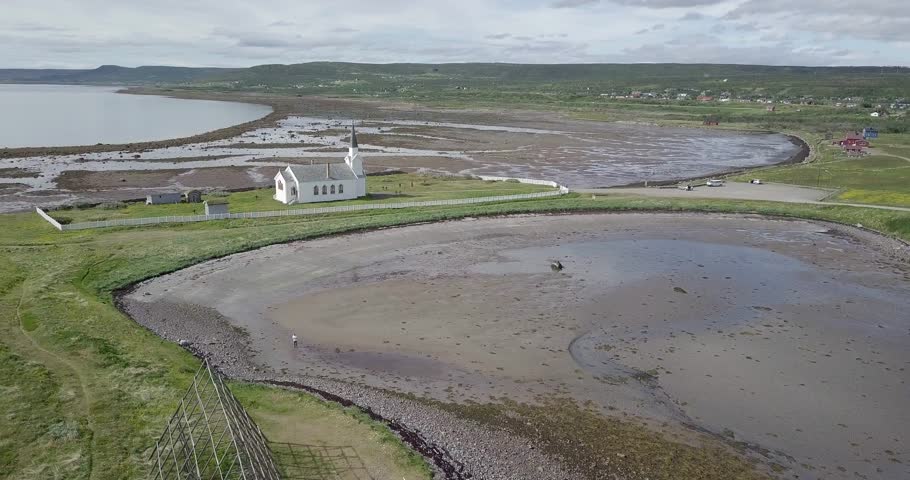 Flying over Isolated Church close to the sea in Norway
Aerial view of isolated church close to the water, Nesseby Kirke Norway

