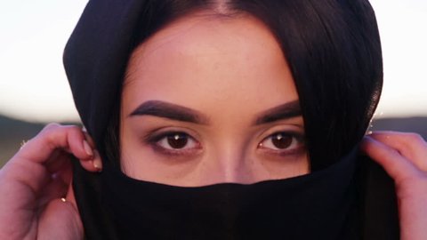 Portrait of a beautiful young arab girl. An Islamic woman in a hijab looks into the camera.