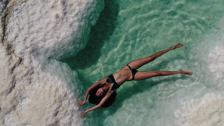 woman floating in the Dead sea salt