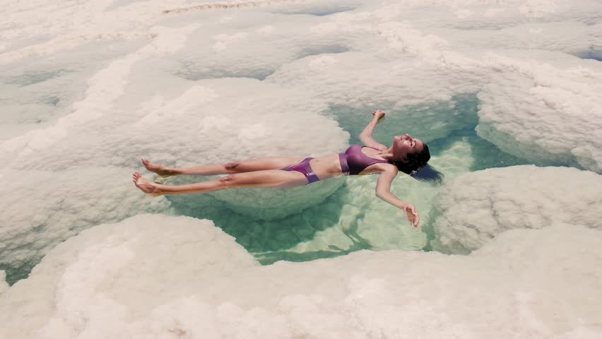 woman floating in the Dead sea salt