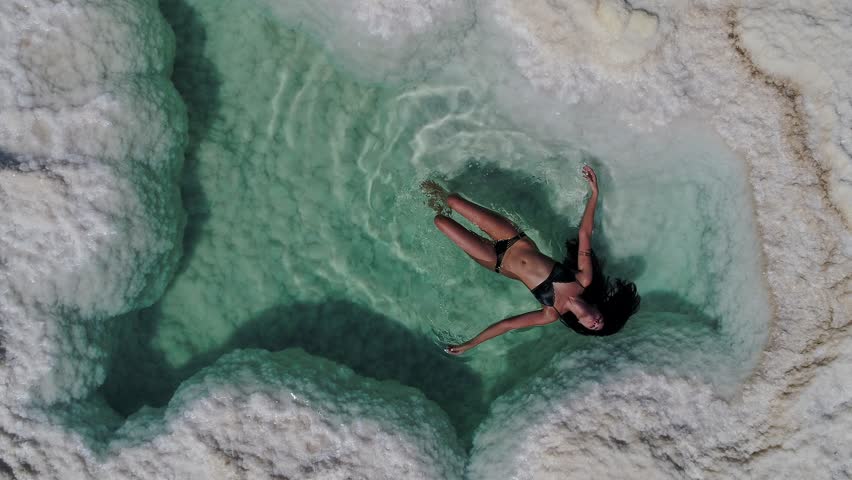 woman floating in the Dead sea salt