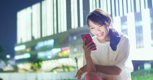 woman use phone happily with shopping mall