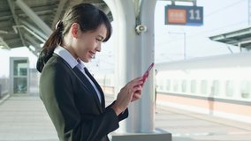 business woman use phone in the station