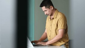 Casual young man using laptop with happy  in modern office,