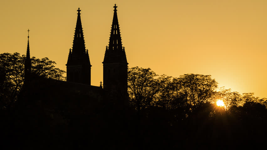 Beautiful high quality colorful sunset timelapse footage with zooming silhouette of Vysehrad castle  in Prague, Czech Republic.