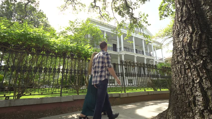 Couple Walking Past French Quarter House, New Orleans (Panning)
