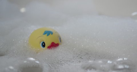 baby toy duck floating in the bathroom
