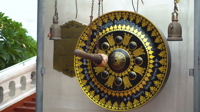 Caucasian Tourist in Asia - Exploring Temple and Hitting Gong