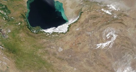Very high-altitude overflight aerial of Caspian Sea, land to its East and South. Clip loops and is reversible. Elements of this image furnished by NASA