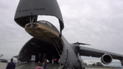 People Boarding Back Of Usa Military Command Aircraft Blurred Out