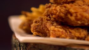 Spinning serving of chicken wings, beer and sauces in a close up low angle view