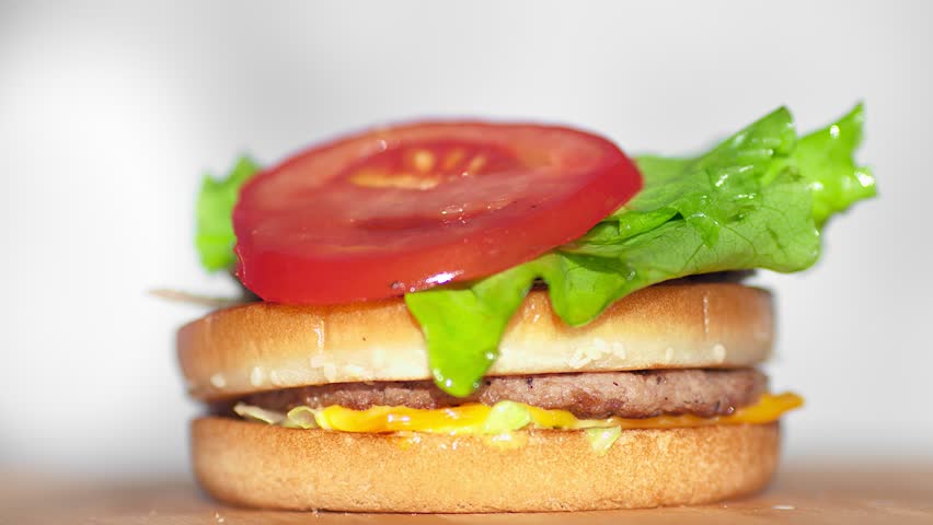 Appetizing fresh bun with sesame seeds to fall on the seductive juicy big burger | Shutterstock HD Video #1017805894