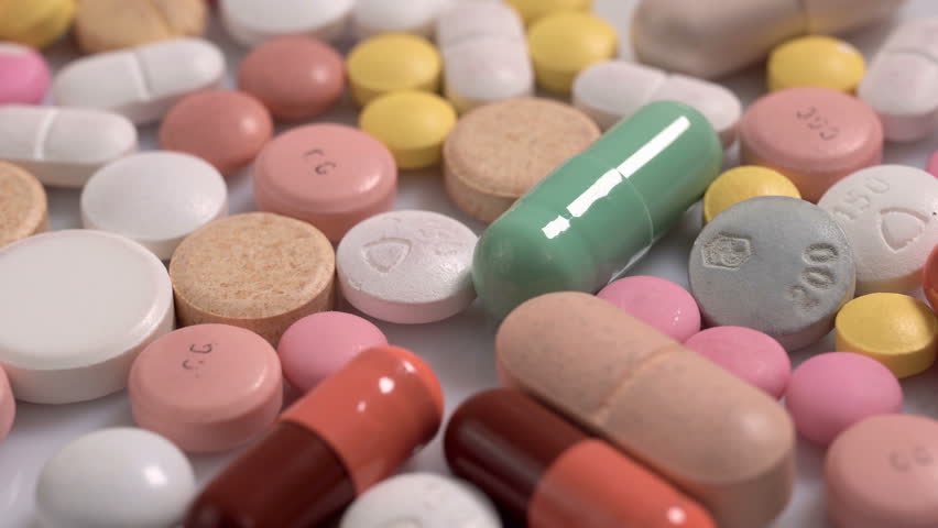 Different colorful pills and capsules. Global pharmaceutical industry for billions dollars per year. Pharmaceutical drugs for use as medications. Studio shot panning. Macro. Royalty-Free Stock Footage #1017809629