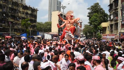 MUMBAI,INDIA, 24 SEPTEMBER 2018 : Devotees carrying idols of elephant headed Hindu god Ganesh for immersion in the Arabian sea in Girgaon Chowpatty, after 10 th day of festivities and prayer