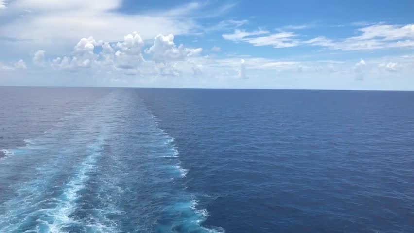 15 second video bautiful blue sky deep blue ocean waves created the wake behind the back of ship 
