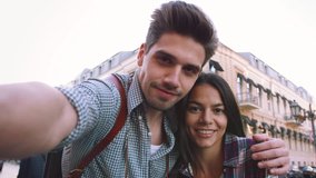 POV of the young mixed race tourist couple taking selfie in old city center and having some fun