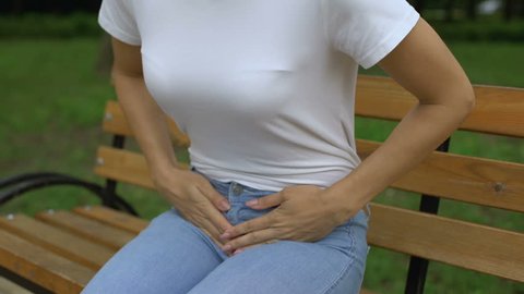 Closeup of woman suffering from period pain, miscarriage, gynecological problem