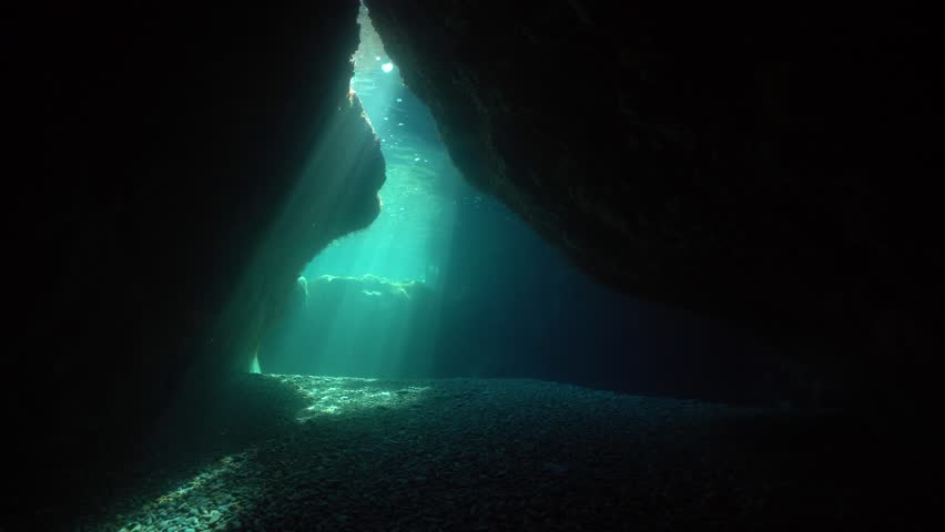 Natural sunlight at the exit of a shallow cave underwater in the Mediterranean sea, Pyrenees-Orientales, Roussillon, France Royalty-Free Stock Footage #1017826978