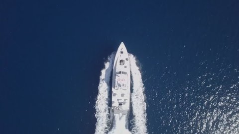 Following a Large speedboat roaring across the Mediterranean Sea - Top down aerial footage.