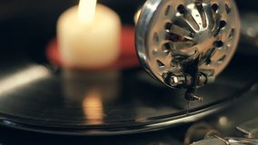 the candle burns on a rotating vinyl record