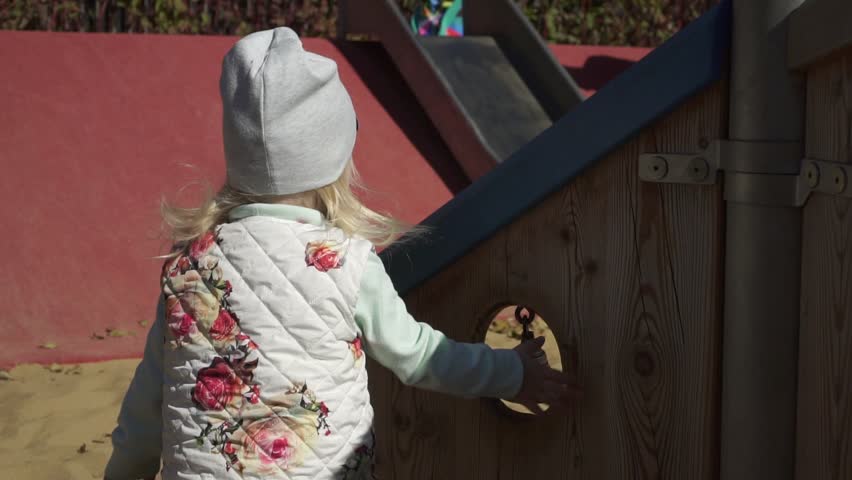 The child plays in the playground