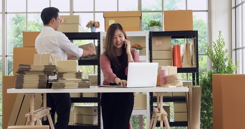 Young Asian couple business  working in simple house office look like doing startup business. Concept for online marketing, SME and home base workplace
