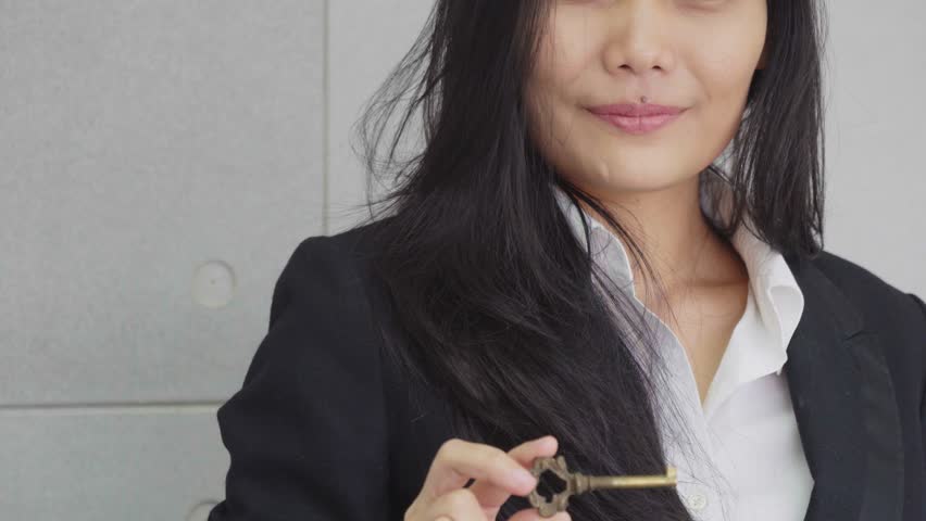 Business female show a key in business concept success