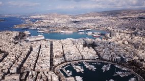 Aerial drone video of iconic round port of Marina Zeas or Pasalimani with boats, yachts and sail boats docked, port of Pireas , Attica, Greece