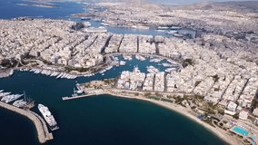 Aerial drone video of iconic round port of Marina Zeas or Pasalimani with boats, yachts and sail boats docked, port of Pireas , Attica, Greece