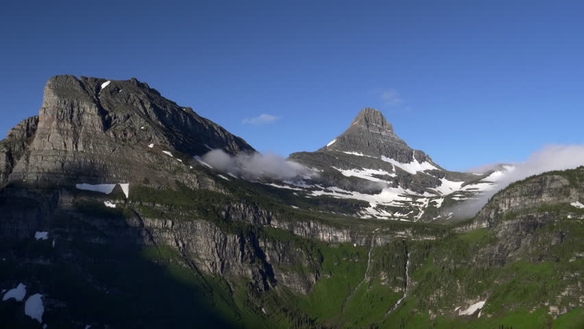 a wide morning view of mt clements and reynolds mountain near logan pass at glacier national park in montana, usa