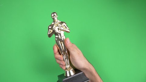 MONTREAL, CANADA - September 2018 : Oscar winner very happy with it's golden trophy on green screen chroma key