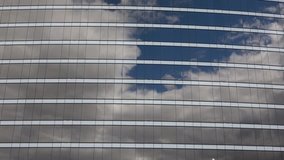 Short clip of reflected clouds in a glass building