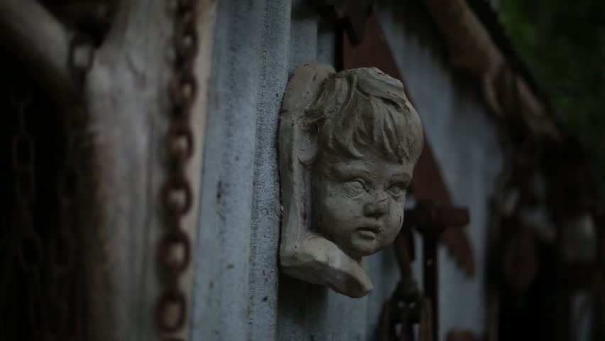 Statue of Head on Wood Shed