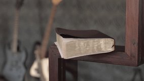 Caucasian male taking a bible from a pulpit