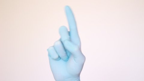 Male forefinger waving in rubber glove