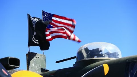 Minden, NV / USA - October 14 2018: American and POW-MIA Flags flying a-top a North American B-25 Mitchell at the 2018 Aviation Roundup Air show in Minden, Nevada