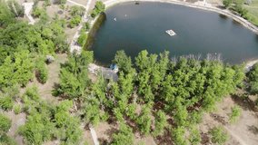 4k Beautiful aerial view of clear emerald lake in city park
