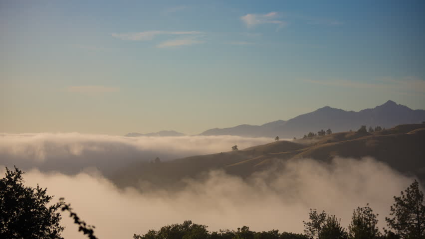 Time lapse clip of fog rolling over the mountains in Big Sur, California
